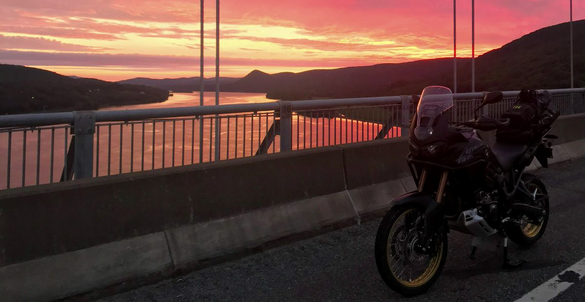 Honda Africa Twin with scenic red sunrise sky